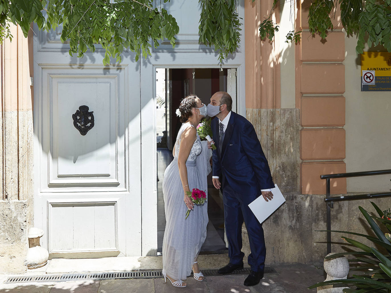 El Covid-19 y las restricciones sociales no han vencido al amor. El Palacete de Monforte reabrió el viernes sus puertas para albergar de nuevo la celebración de bodas civiles. Los primeros novios confiesan que no se imaginaban darse el beso del 'sí quiero' con mascarilla y posponen el banquete y el viaje. 