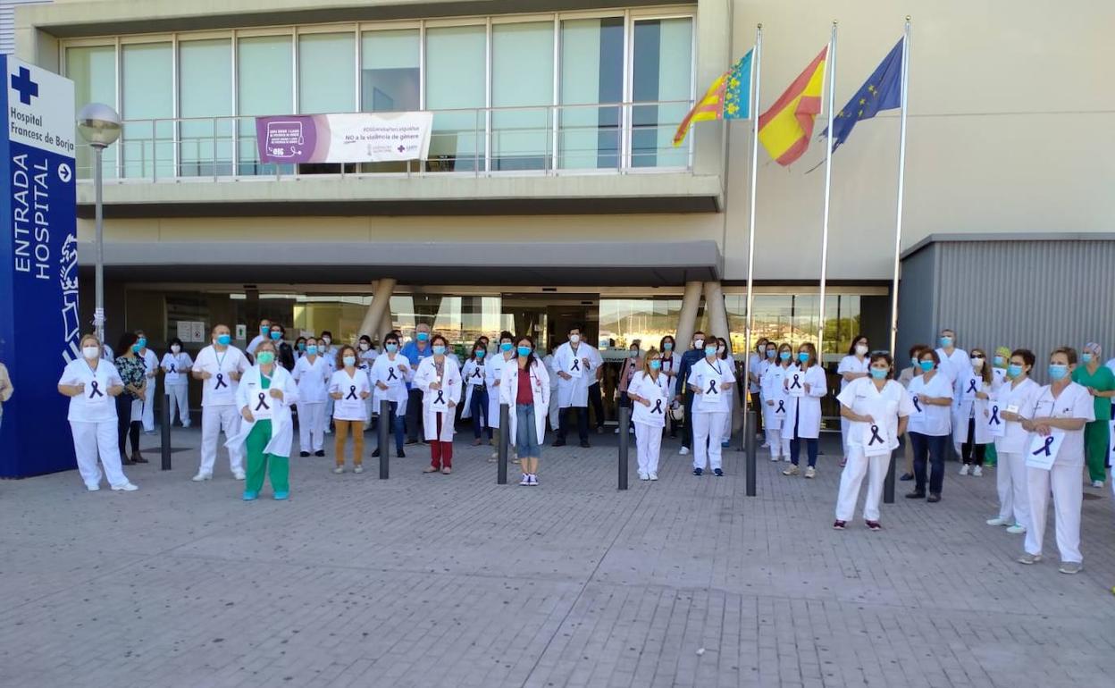 Compañeros del celador fallecido se concentran en señal de duelo a las puertas del hospital Francesc de Borja de Gandia, ayer.