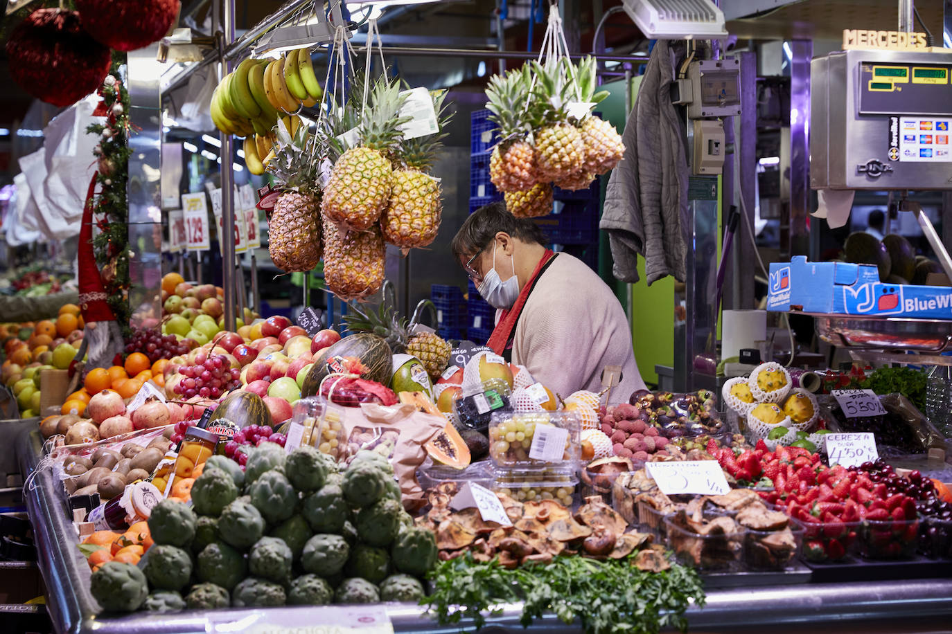 Con la Navidad a la vuelta de la esquina, los valencianos aprovechan para disfrutar del ambiente y realizar las compras en los mercados de la ciudad. La celebración de las fiestas navideñas este año será atípicas y con restricciones por la pandemia del coronavirus. En imagen, el Mercado del Cabaynal este martes.