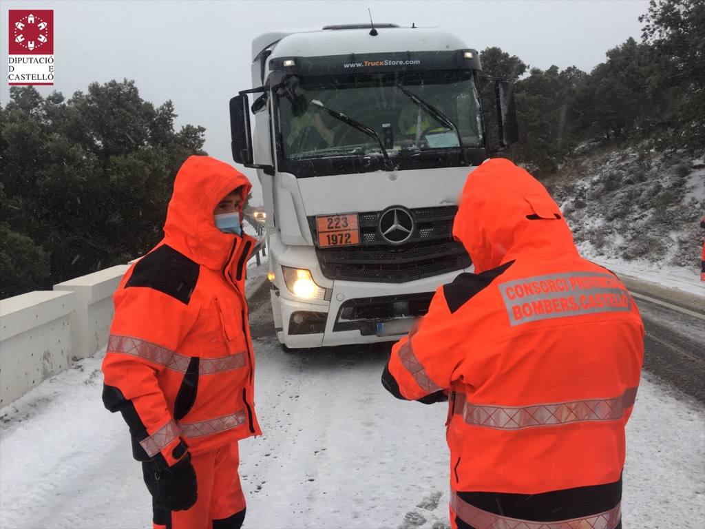 Los bomberos asisten a un camión de mercancías peligrosas bloqueado por el hielo y la nieve en el Coll d’Ares.