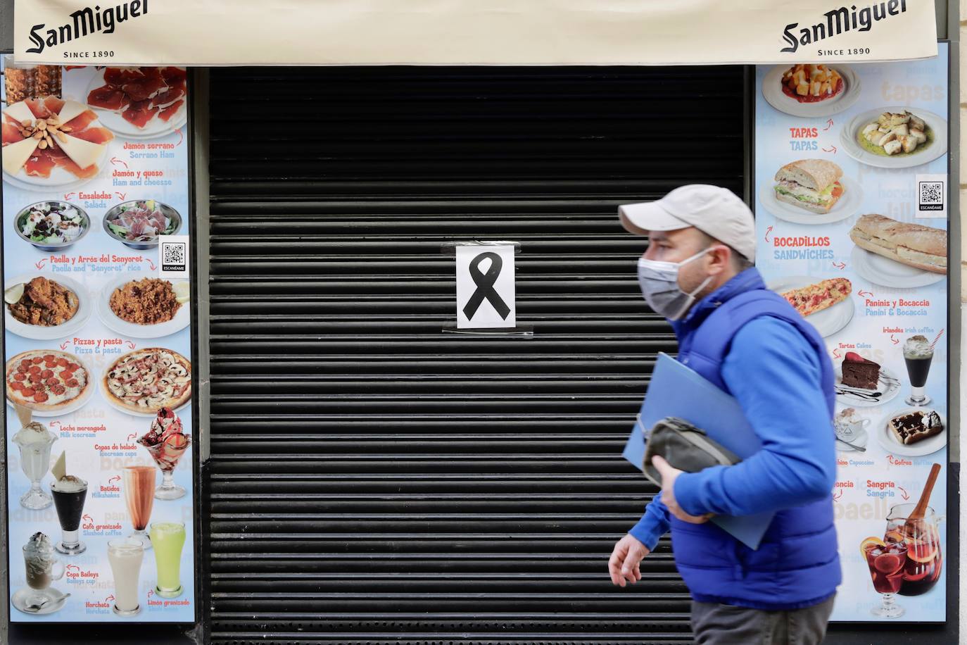 La hostelería de Valencia permanece totalmente cerrada, al menos durante los próximos 14 días, desde este jueves 21 de enero. Así lo estipulan las nuevas medidas tomadas por parte del Consell para tratar de frenar el avance de la pandemia de coronavirus en la Comunitat, que fueron anunciadas el pasado martes 19. La restricción deja multitud de persianas bajadas, en las que se ven algunos crespones negros en señal de protesta silenciosa, y calles sin terrazas ni vida en el centro de la ciudad. 