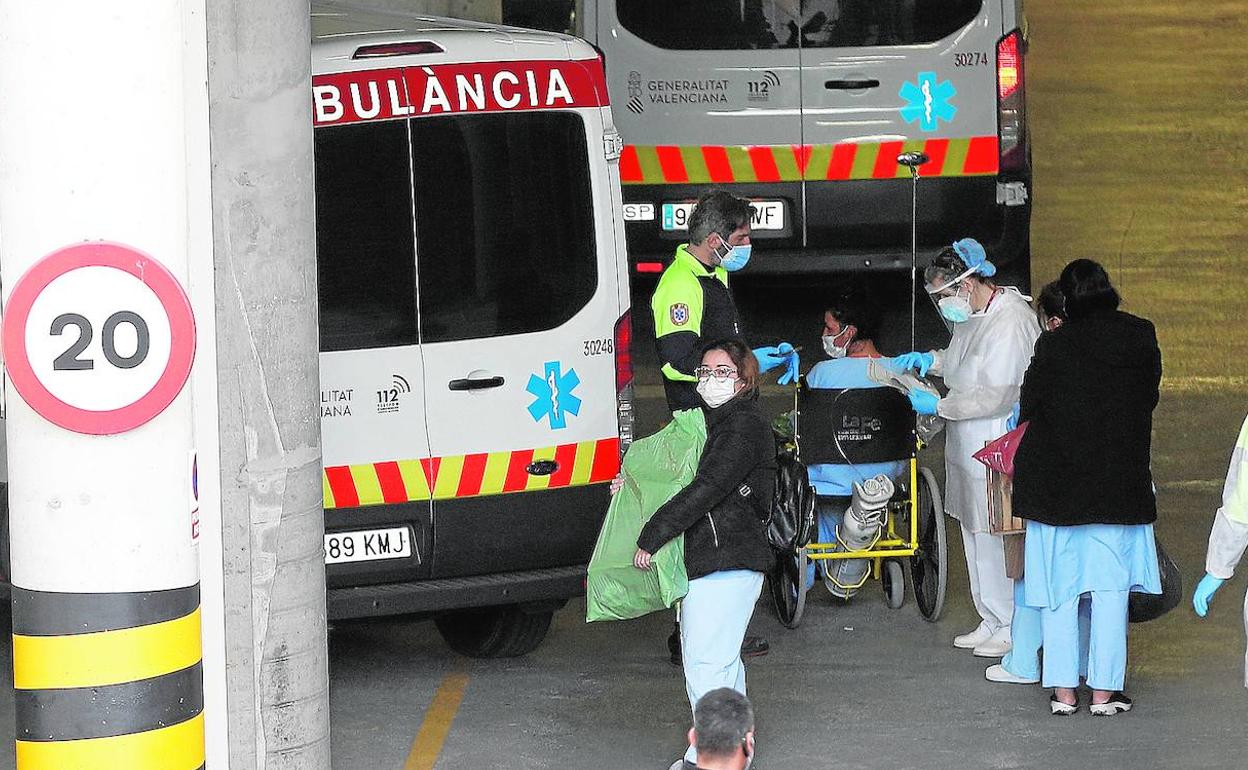 Personal sanitario evacúa a una de las pacientes desalojadas ayer del hospital de campaña de La Fe.