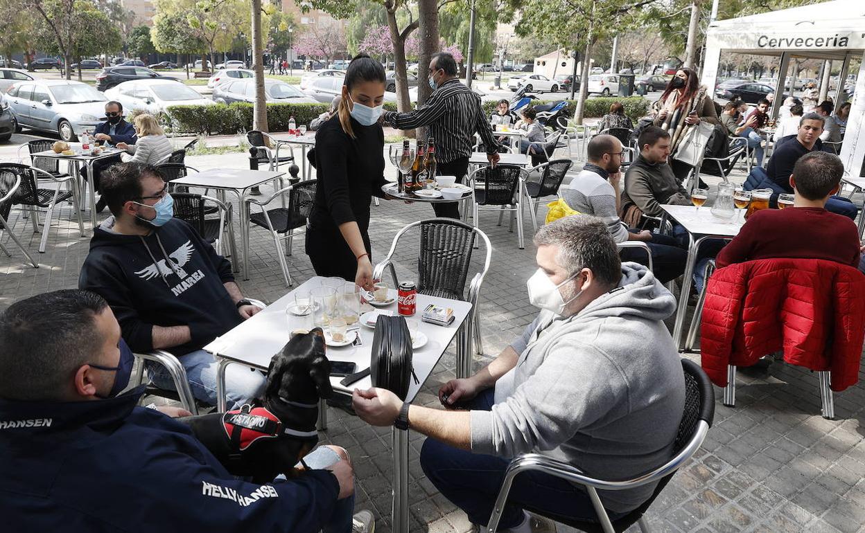 Varias personas consumiendo en una terraza tras el alivio de las restricciones en Valencia. 