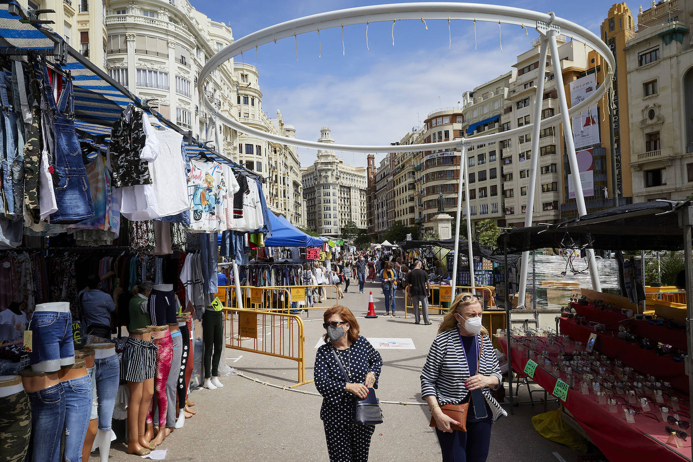 Protestas, mercadillos y restos de instalaciones se mezclan junto a la plaza del Ayuntamiento. Comerciantes y vecinos de la zona insisten en los problemas para acceder en coche mientras el monolito del 15M sigue protegido por vallas.