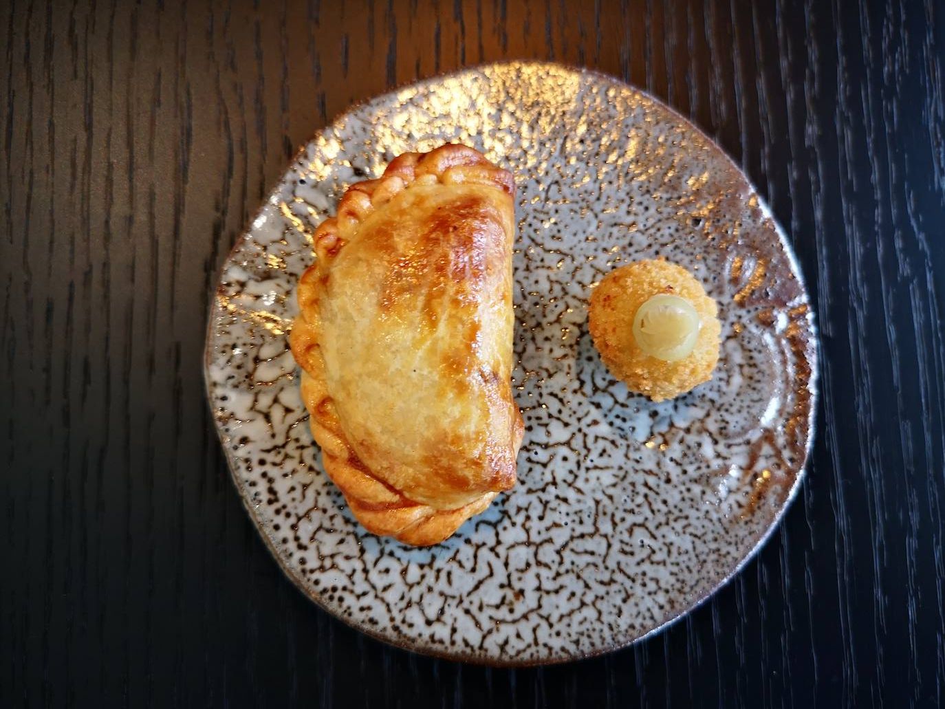 Es una de las bendiciones del menú. Desde que emprendieron en solitario su aventura como cocineros que les acompaña la empanadilla como talismán. Hablan de sus raíces y de su familia. La receta de mamá Justina y las manos confiteras de Carito. Un lujazo.