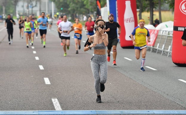 Una atelta, a punto de cruzar la línea de meta en la carrera 'Tornem', la primera en Valencia después de 14 meses. 