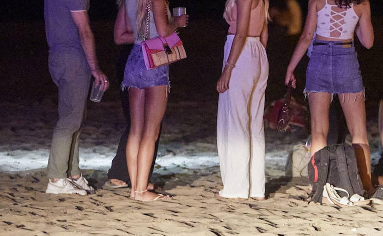 Un grupo de jóvenes en la playa durante la noche de San Juan. 