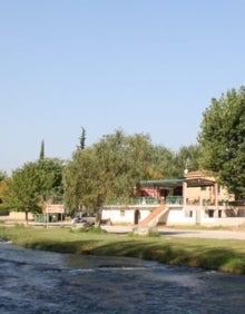 Imagen secundaria 2 - Arriba, la playa fluvial de Bugarra, en el río Turia. Abajo a la izquierda, un hombre pescando en el coto de pesca de Bugarra-Pedralba. A la derecha, el río Turia a su paso por Bugarra. 