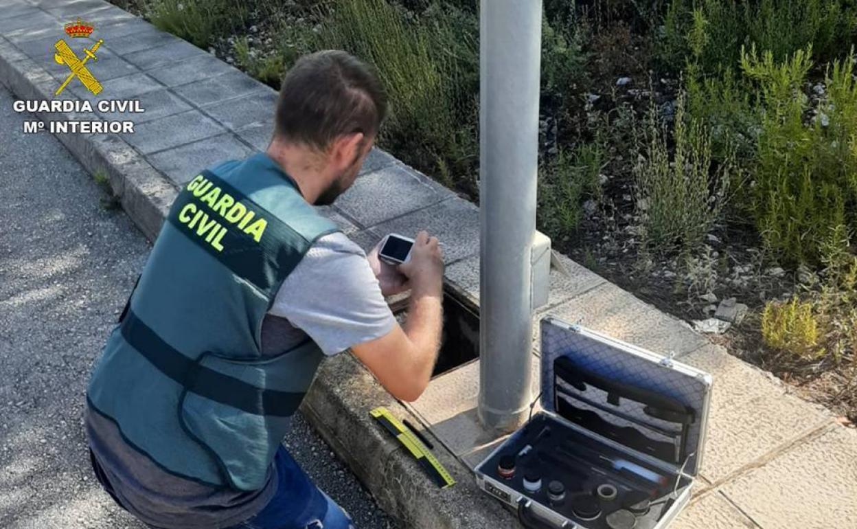 Un agente de la Guardia Civil investigando el robo de cableado. 