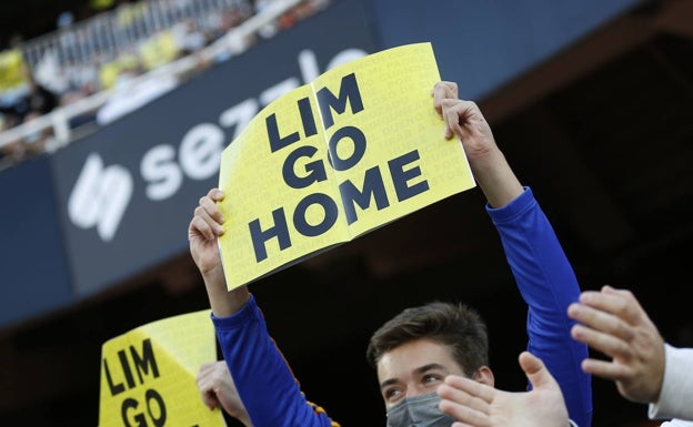 Un aficionado muestra un cartel durante el partido ante el Atlético en Mestalla. 