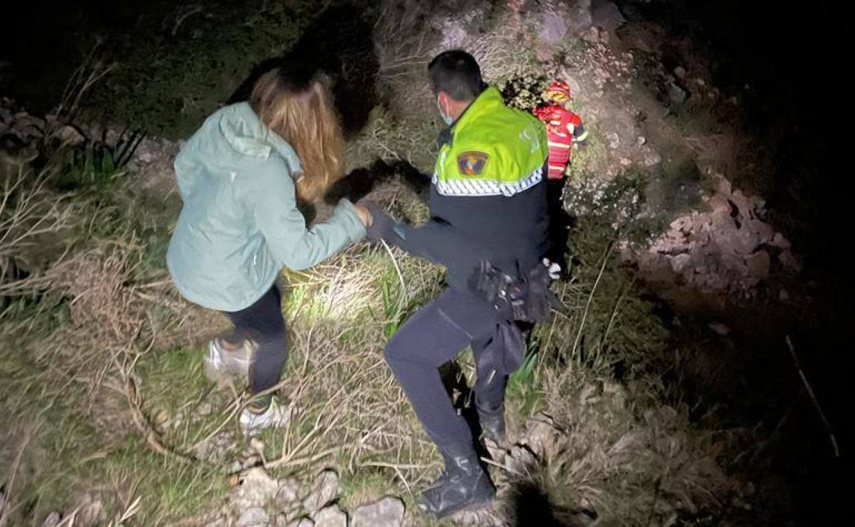 Un agente ayuda a una de las excursionistas durante el rescate. 