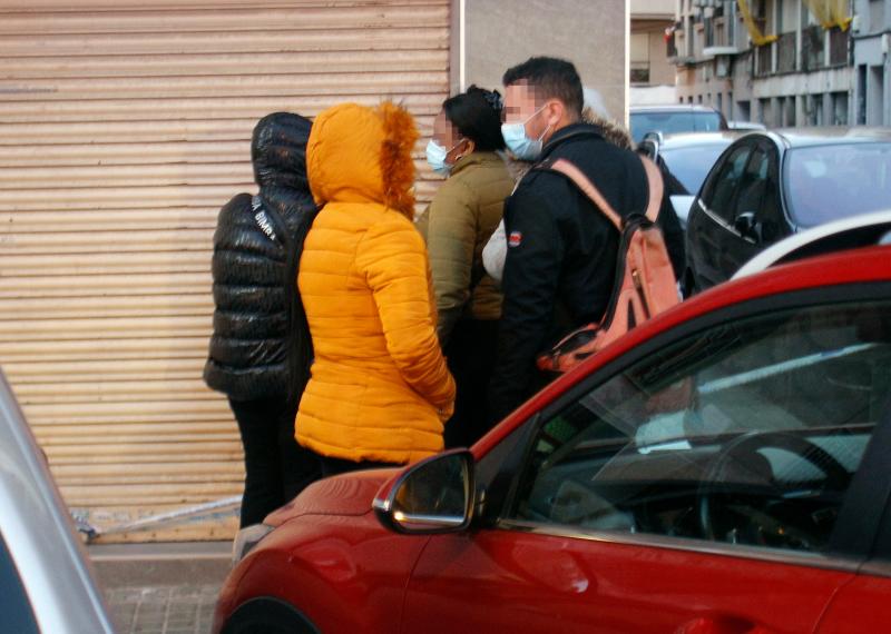 Un agente de la Policía conversa con los rehenes evacuados del domicilio.