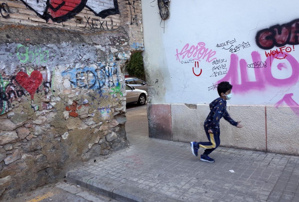 Un niños pasa por el llamado «agujero de la vergüenza» de la calle Agustín Lara. txema rodríguez
