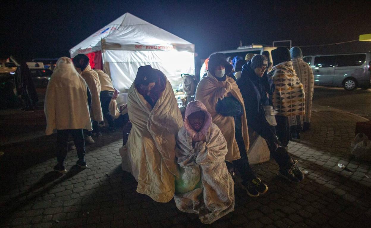 Un grupo de refugiados abrigados con mantas en la ciudad polaca de Pzremysl. 