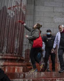 Imagen secundaria 2 - La fachada del Congreso tras la protesta; la Policía desalojando a los manifestantes; y una mujer pinta una de las columnas. 