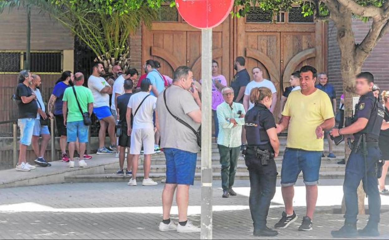 Dos policías apaciguan los ánimos de los vecinos poco después del tiroteo. 