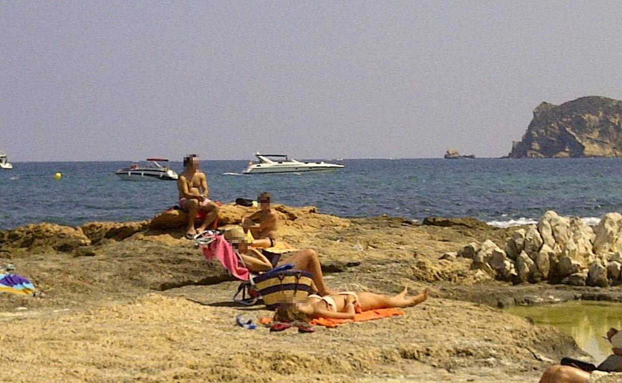 Imagen de archivo de unos turistas tomando el sol en una cala de Xàbia. 