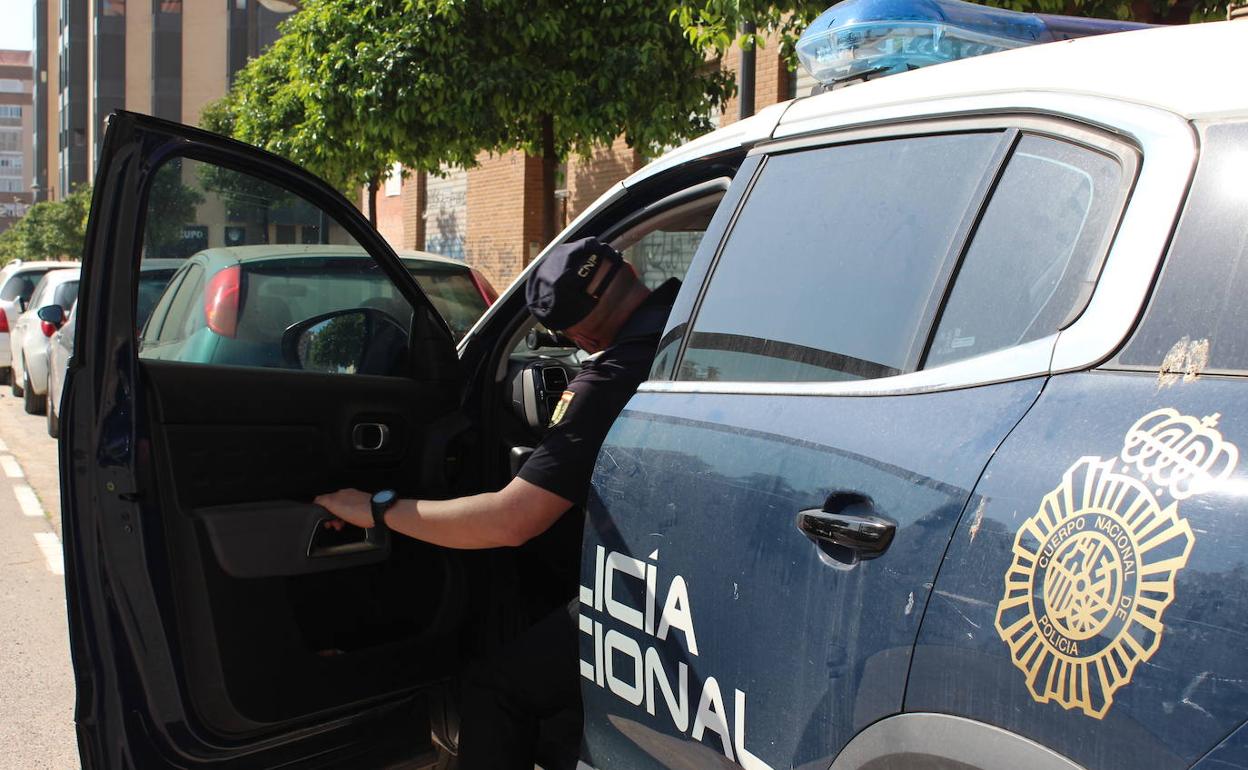 Un agente en un coche de la Policía Nacional. 