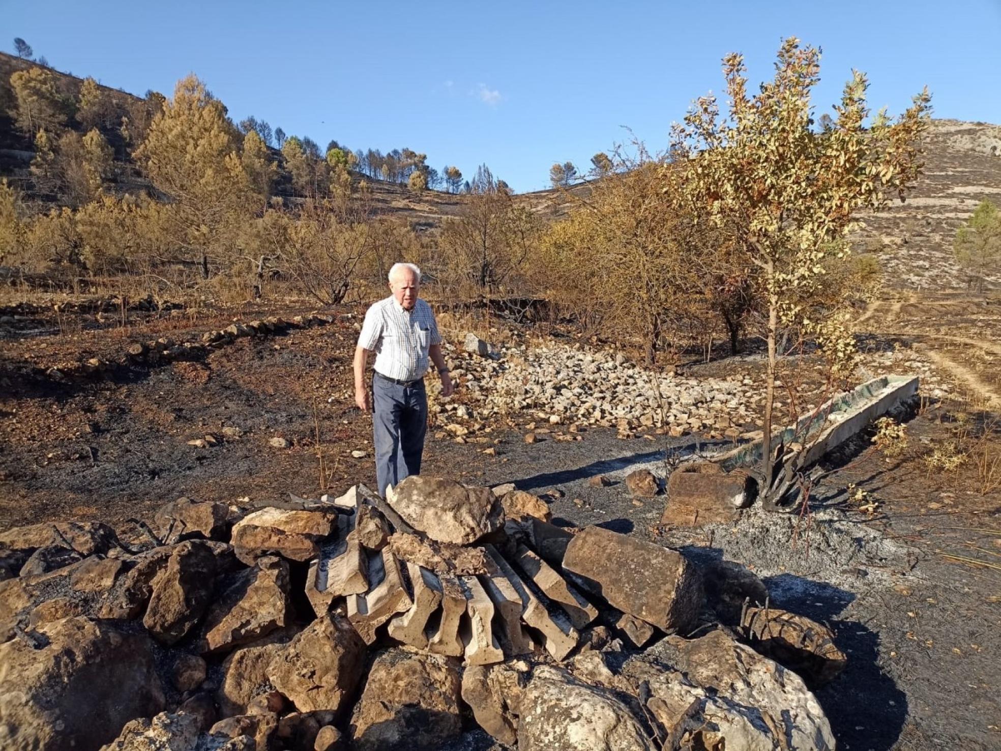 Un vecino de Fageca mira desolado el efecto del fuego en el barranco de Malafí. 