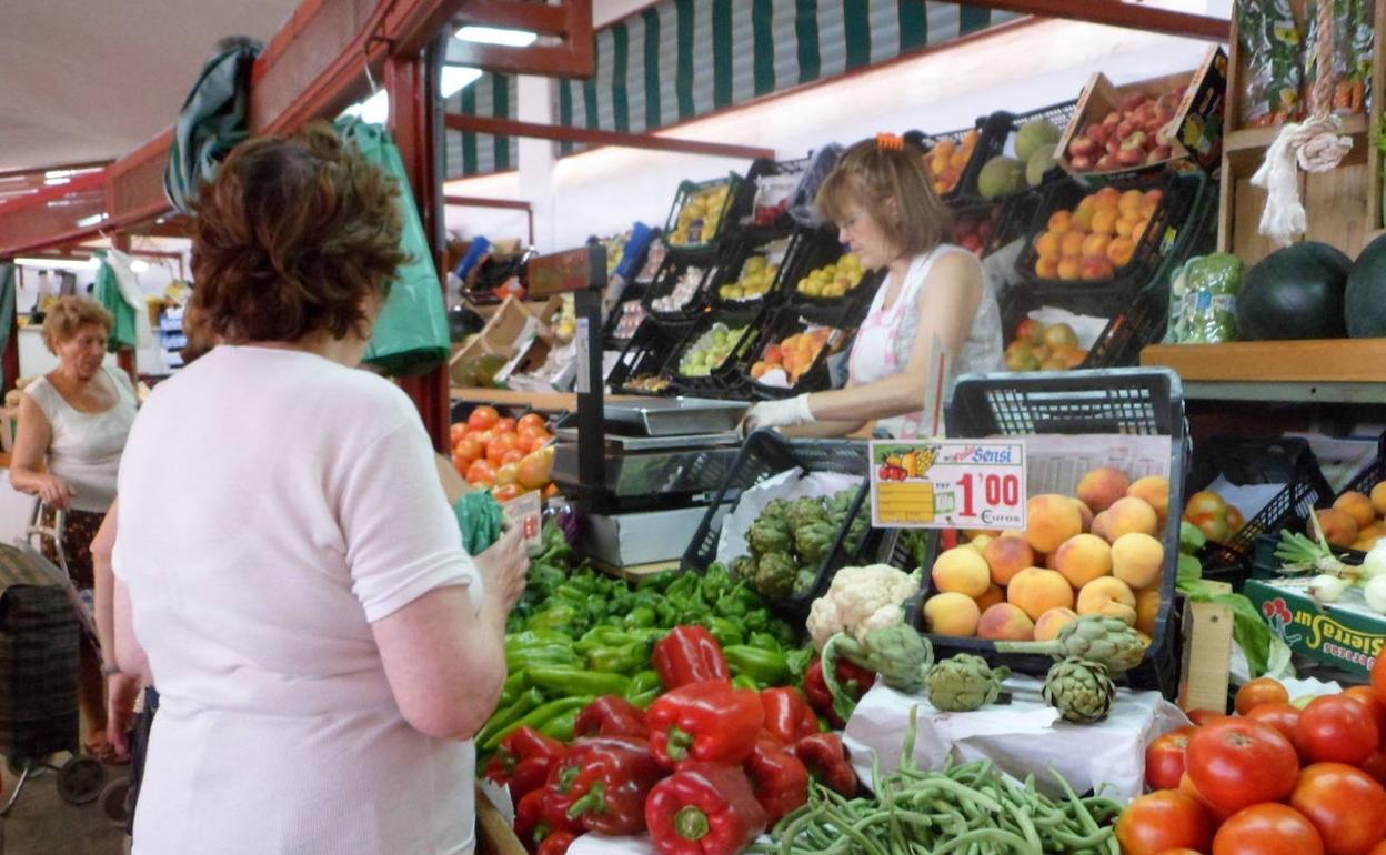 Un puesto de fruta y verdura en un mercado. 