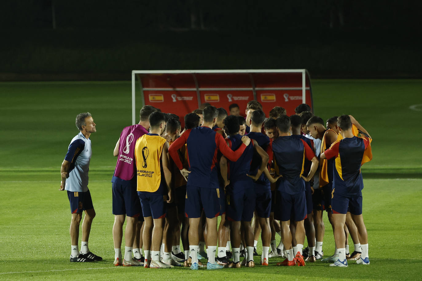 Luis Enrique observa mientras sus jugadores reciben instrucciones de sus ayudantes.