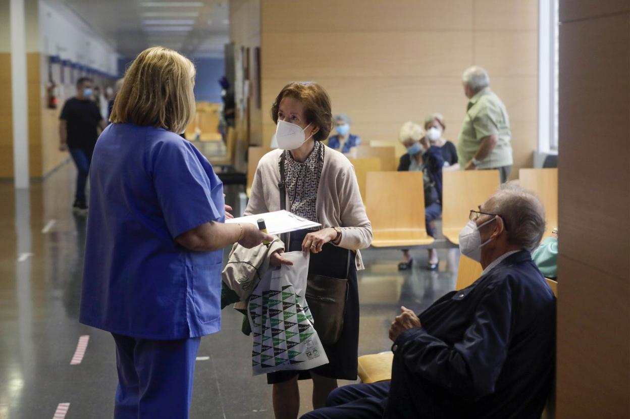 Personal sanitario informa a una paciente sobre la campaña de vacunación Covid.