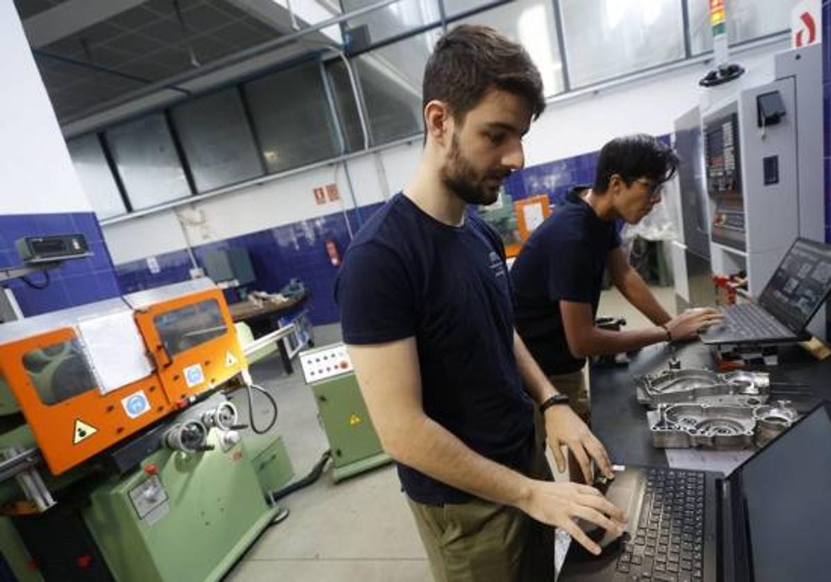 Dos estudiantes frente al ordenador.