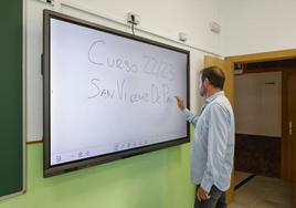 Un profesor, con una pizarra digital.