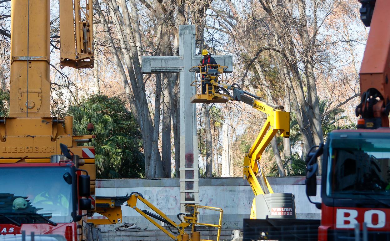 Operarios trabajan en el traslado de la cruz. 