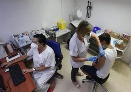 Un sanitaria vacuna a un paciente en un centro de salud valenciano.