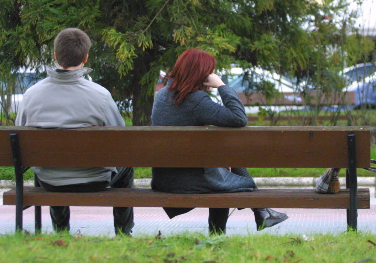 Una pareja en un banco tras una discusión, imagen de archivo.