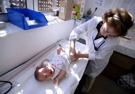 Una pediatra atiende a un bebé en la consulta.
