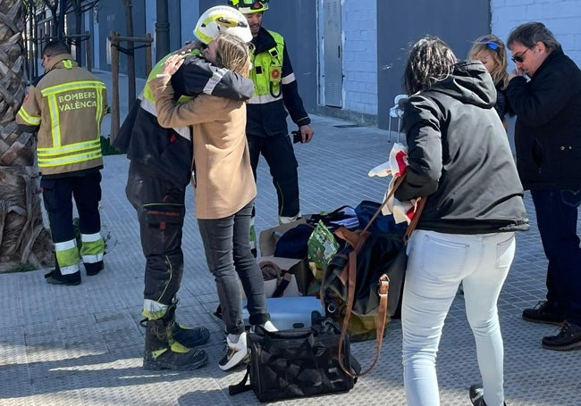 Andrea se abraza con uno de los bomberos que ha encontrado a 'Coco'.