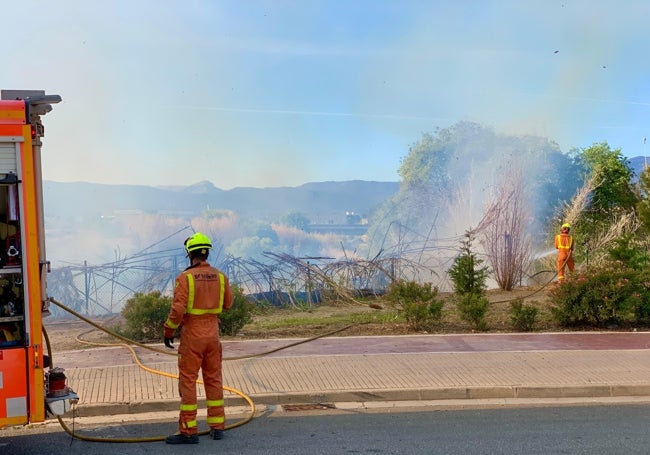 Bomberos trabajando en la extinción del fuego.