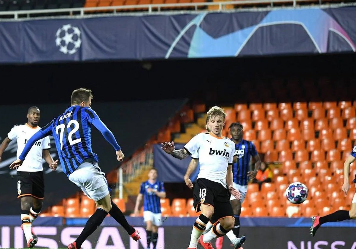 Ilicic, disparando ante Wass, en el Valencia-Atalanta que se jugó ya con Mestalla vacío.