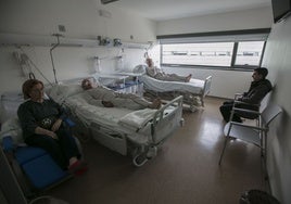 Pacientes y acompañantes en una habitación de un hospital.