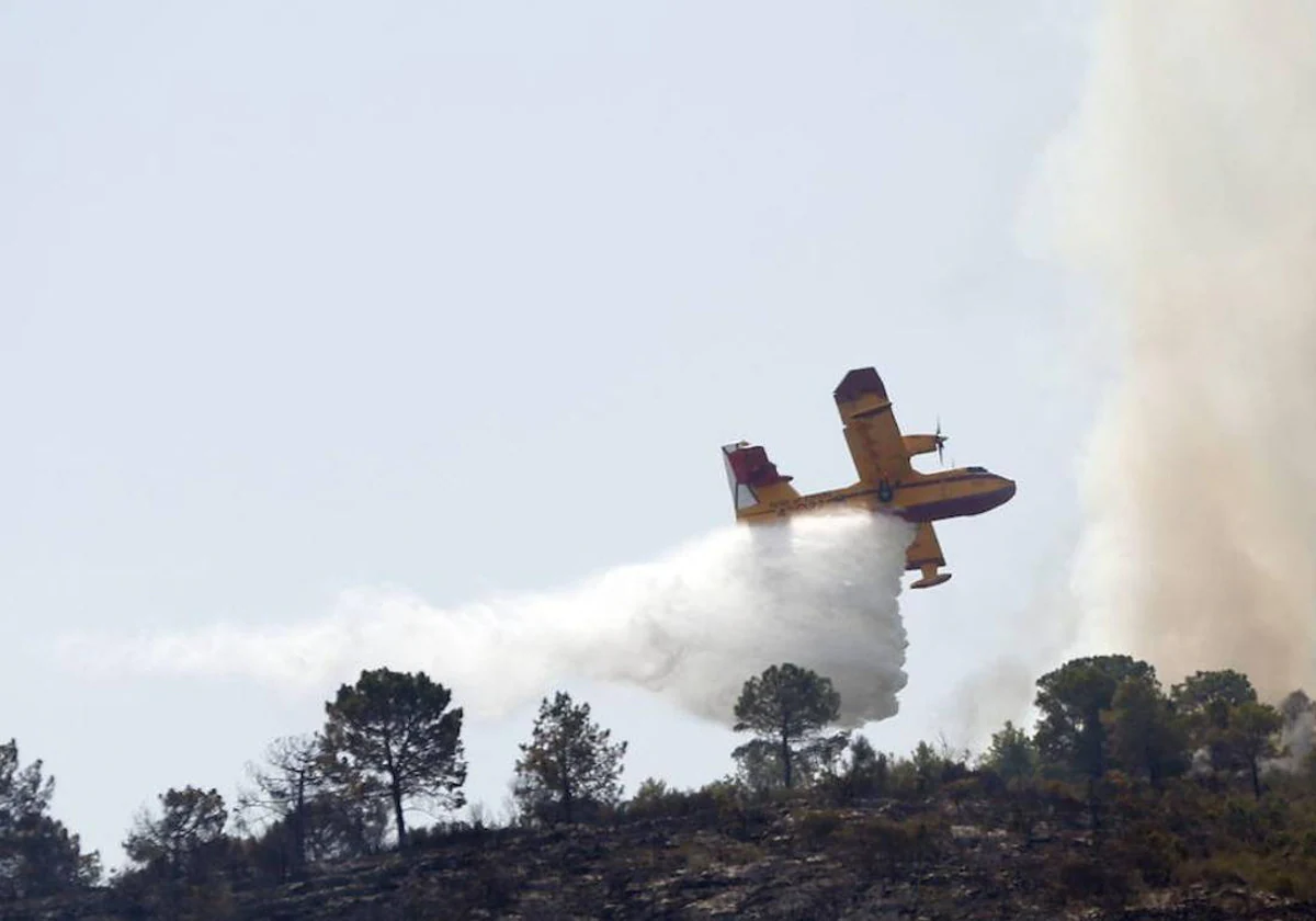 Medios aéreos y terrestres luchan para extinguir un incendio en Soneja 