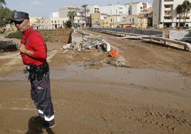 Un policía foral de Navarra corta el paso a los viandantes en el Pont Vell de Paiporta