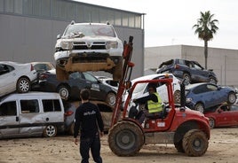 Traslado de uno de los coches siniestrados por la riada en Sedaví.