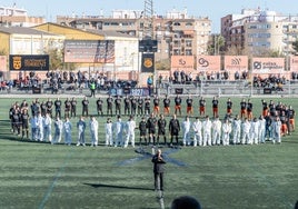 Jugadores de la Asociación de Futbolistas del Valencia, voluntarios y jugadores del Torrent forman un círculo previo al inicio del partido