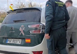 Uno de los sospechosos es trasladado por un agente de la Guardia Civil.