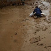 Una mujer resbala en una calle de Paiporta, dos semanas después de la riada.