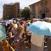 Público asistente al Besamanos del miércoles, refugiándose del sol con paraguas.