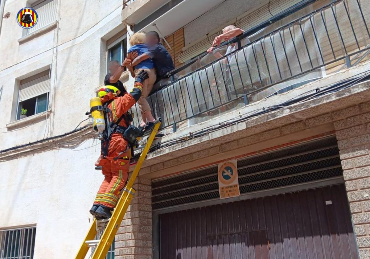 Los bomberos rescatan a una de las mujeres atrapadas.