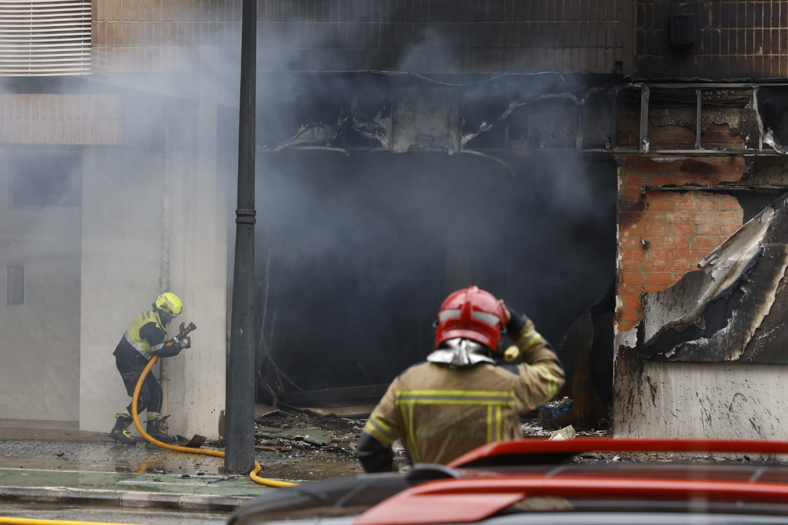 FOTOS | Cinco intoxicados por inhalación de humo tras un espectacular incendio en un bajo comercial de la avenida del Puerto