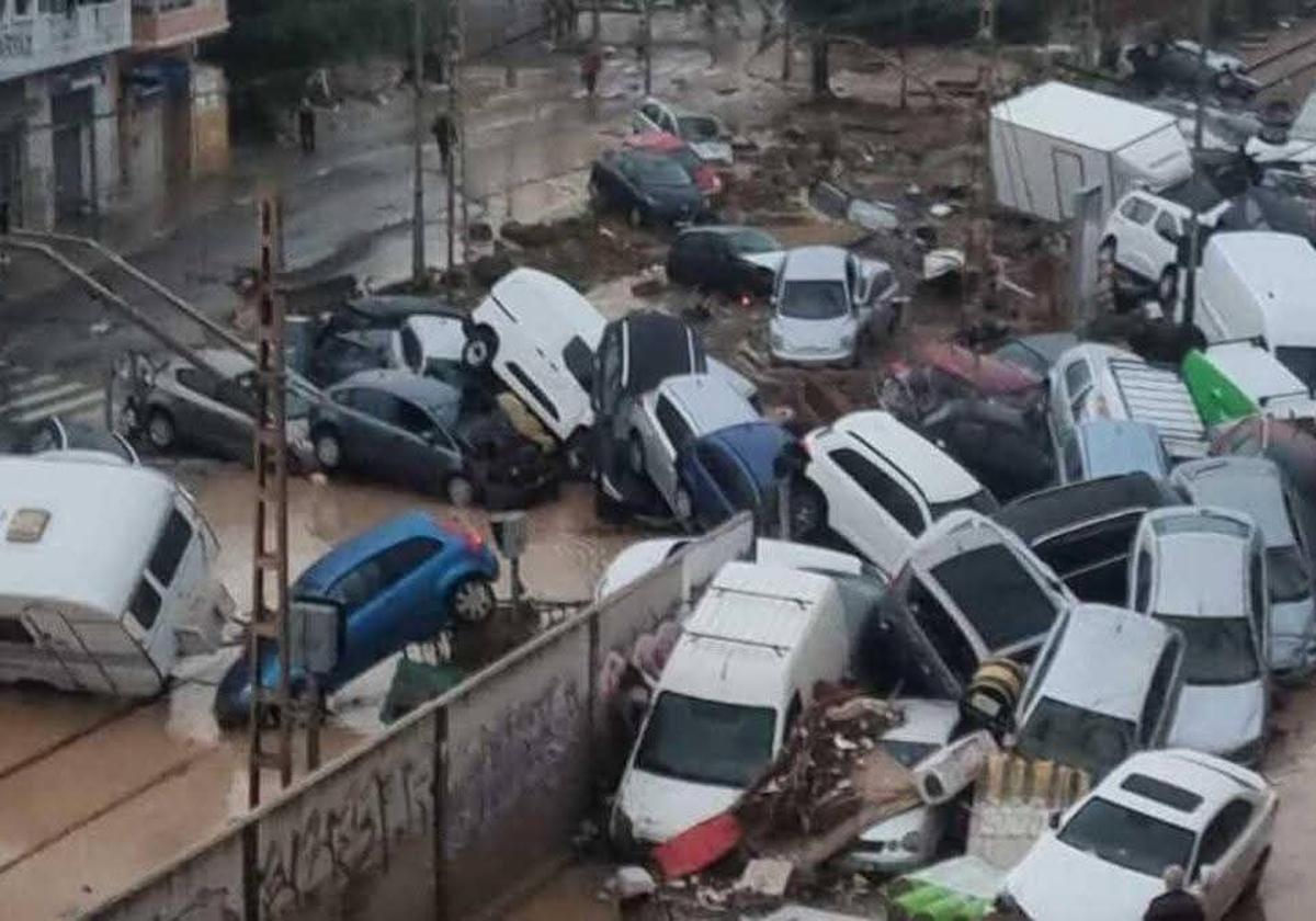 Paso a nivel atestado de coches amontonados tras la dana.