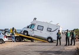 Una grúa retira la autocaravana de la víctima.
