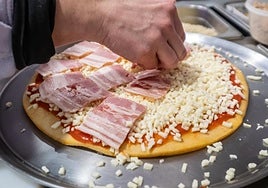 Elaboración de una pizza en un restaurante.