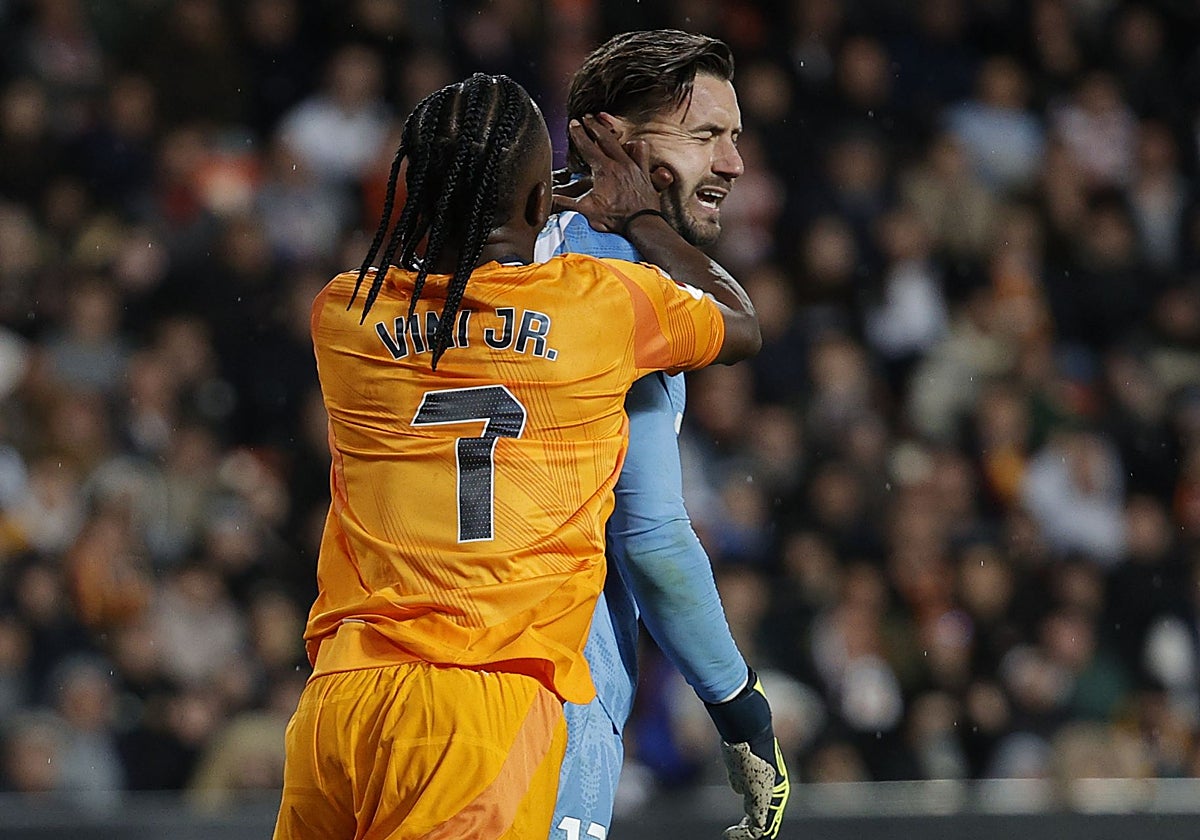 Dimitrievski recibe un empujón de Vinicius en Mestalla.