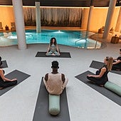 Varias personas asisten a una clase de yoga.